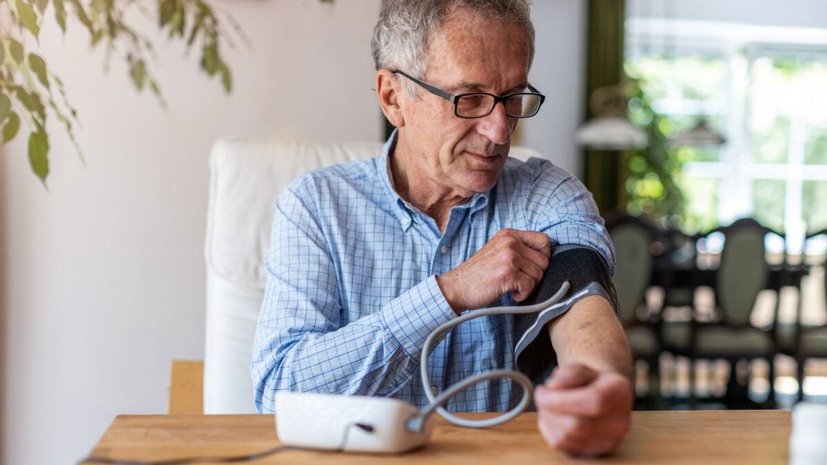 Elderly patient taking blood pressure at home